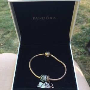 Rose gold pandora bracelet and three charms
